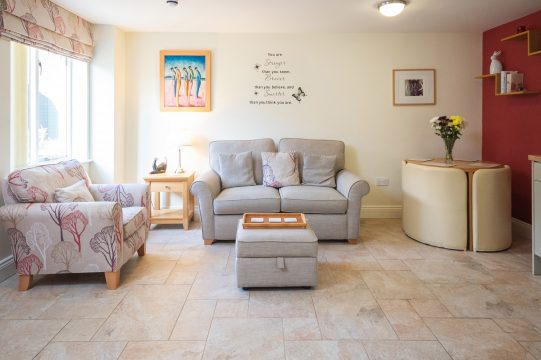 Granary Cottage, holiday cottage in Benhall - sitting room with sofa, armchair and small dining table
