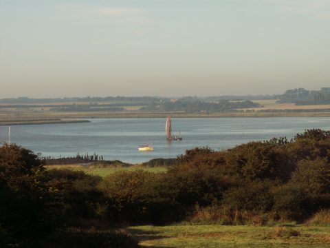 Beaver Cottage, riverside holiday cottage in Aldeburgh - view over the river estuary with sailing boats and open farmland beyond