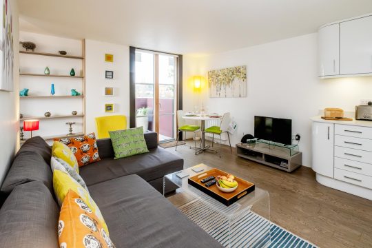 Regatta studio apartment, Thorpeness - open-plan living area with corner sofa, dining table and kitchen