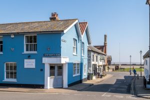 Seagulls, Aldeburgh - blue-painted corner house on Wentworth Road with the seafront beyond