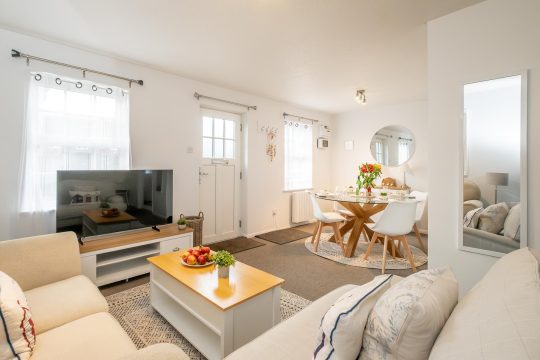 Driftwood, three bedroom timber bungalow in Thorpeness - living room with television, coffee table and round dining table
